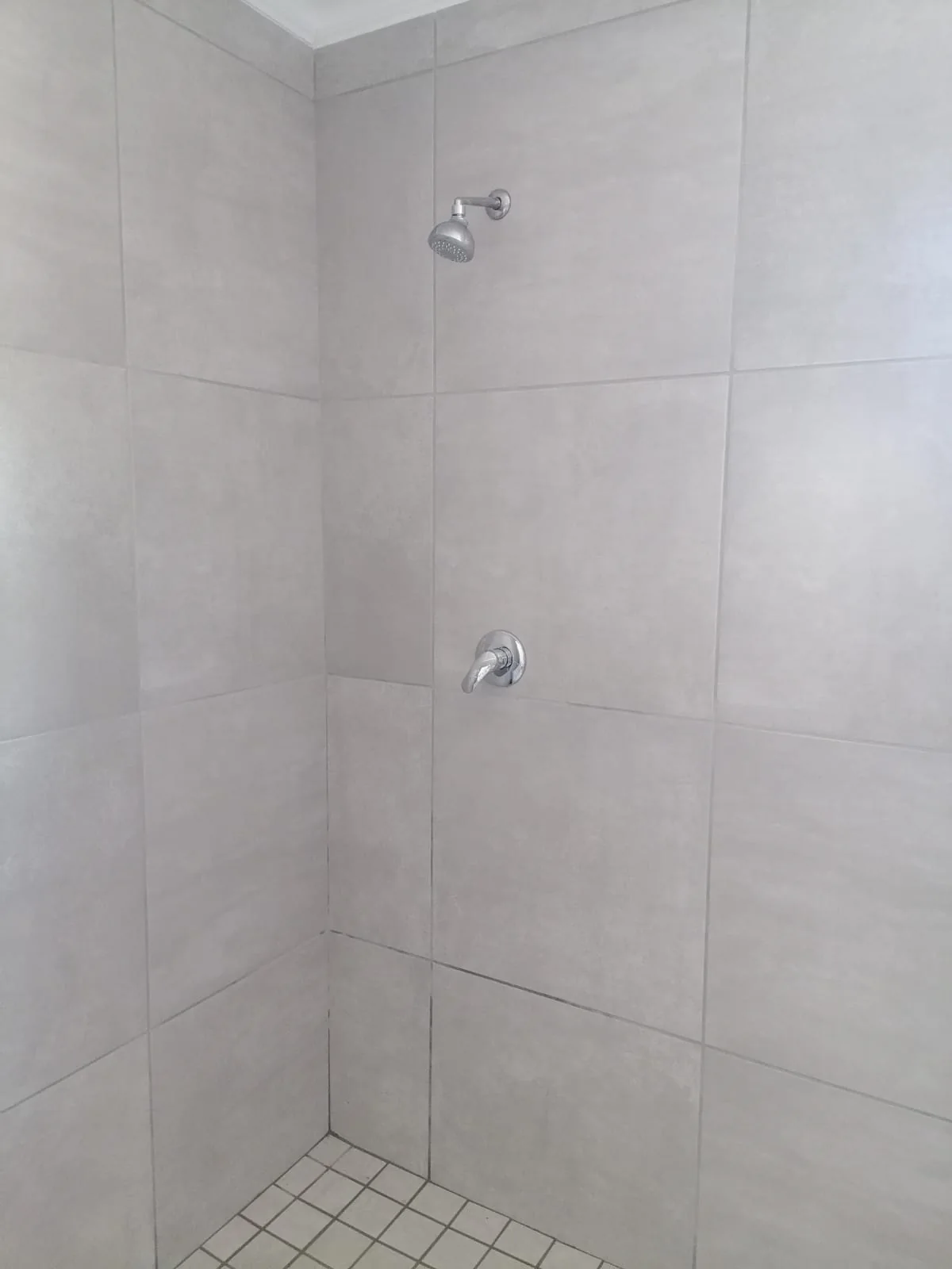 Completed tiled shower and plumbing fixture