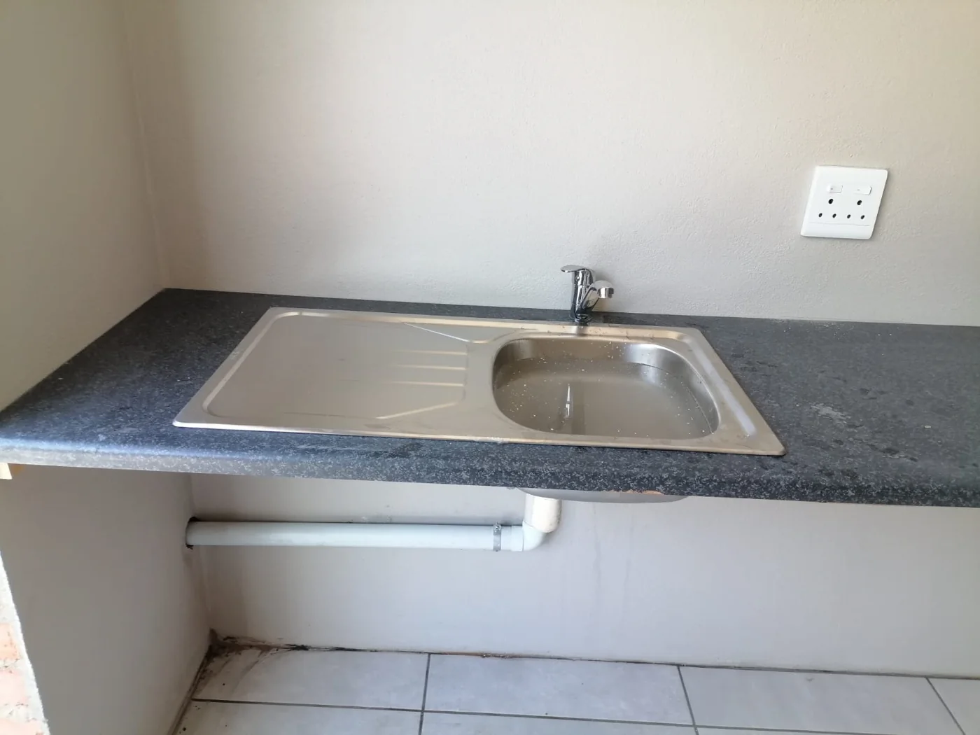 Completed kitchen sink and pipe installation